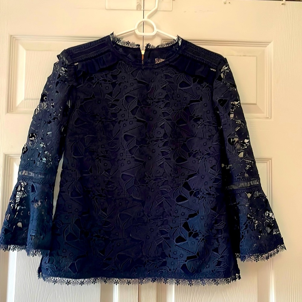 Ted Baker London lace top. Lined front and back. Sheer sleeve with bell detail.